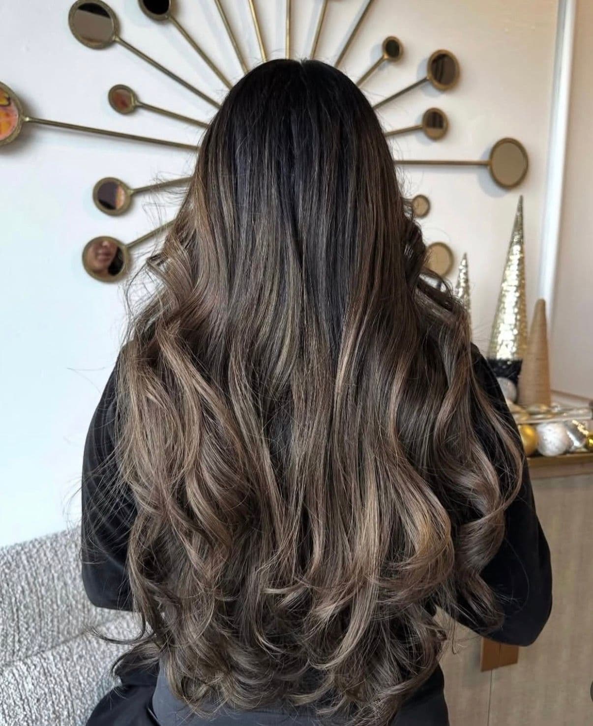 Dark to ash blonde balayage with soft curled ends